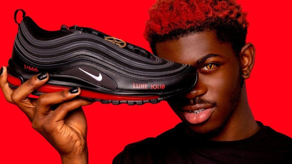 Špeciálna "Satanovská" edícia tenisiek Nike Air Max, ktorá bola vytvorená spoločnosťou MSCHF a promoval ich spevák Lil Nas X (na fotografii).