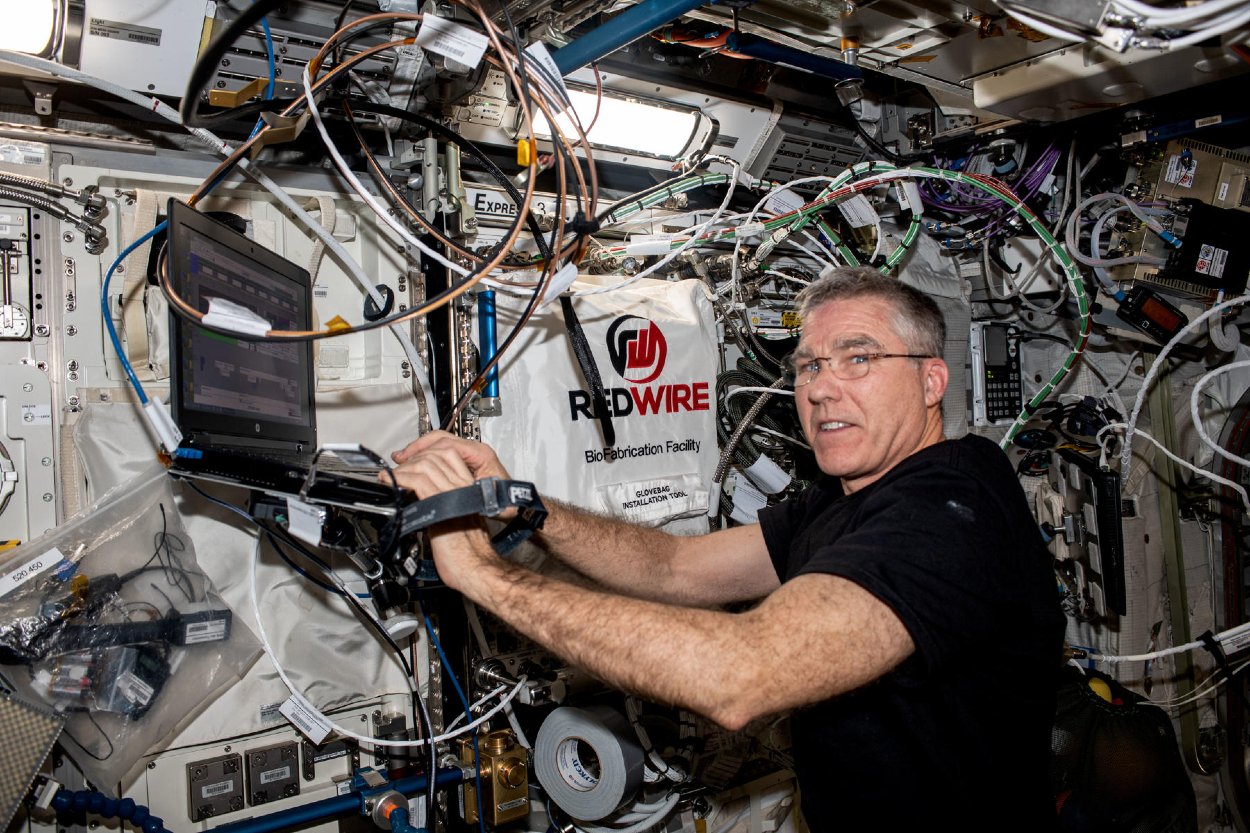 Astronaut Stephen Bowen pracuje v biofabrikačnom zariadení na palube ISS.