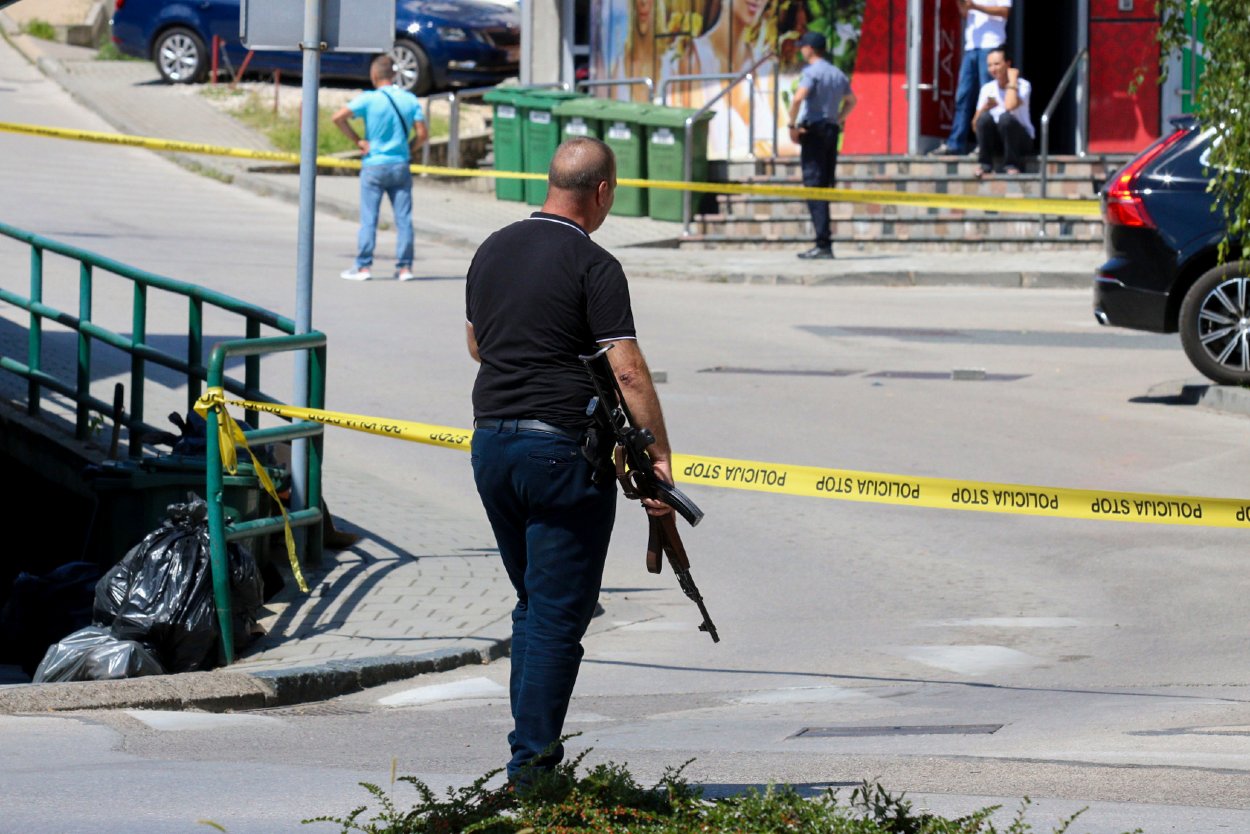 Na snímke príslušník polície v civile na mieste streľby, pri ktorej prišli o život najmenej traja ľudia a ďalší utrpeli zranenia v mestečku Gradačac v Bosne 11. augusta 2023.